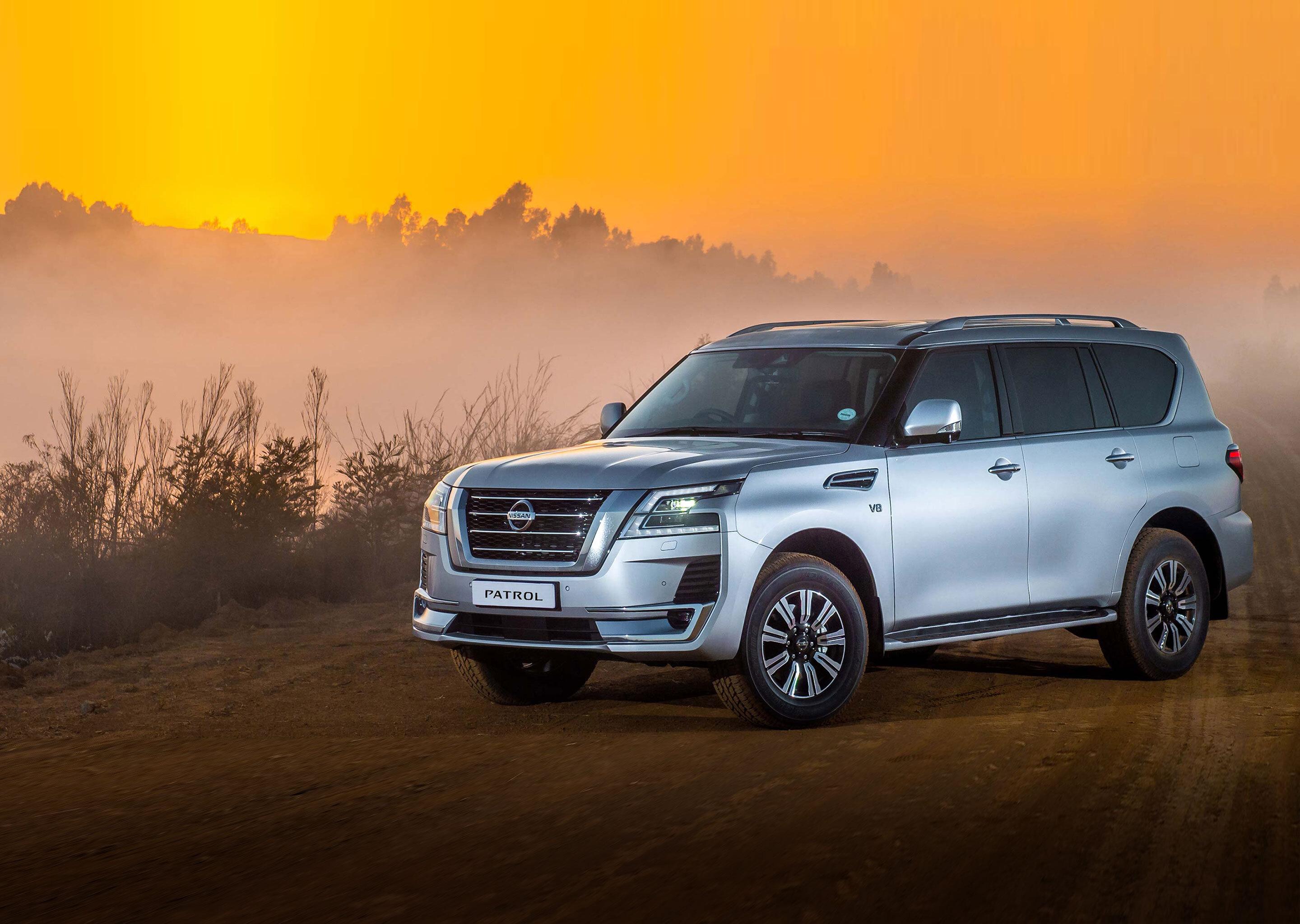 Nissan Patrol in sandy road and sunset